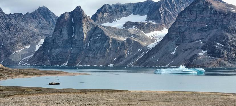 Boat and Iceberg in a Fjord in Greenland