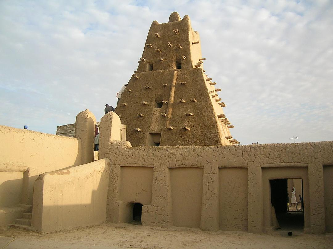 A tower made from sandstone, with wooden sticks sticking out of it