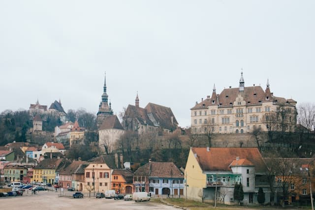 Beige and brown gothic building on a hill