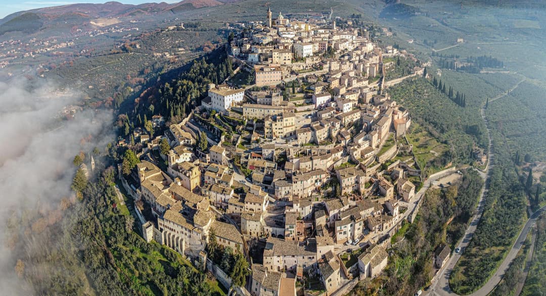 Aerial view of ancient San Marino city on lush hill