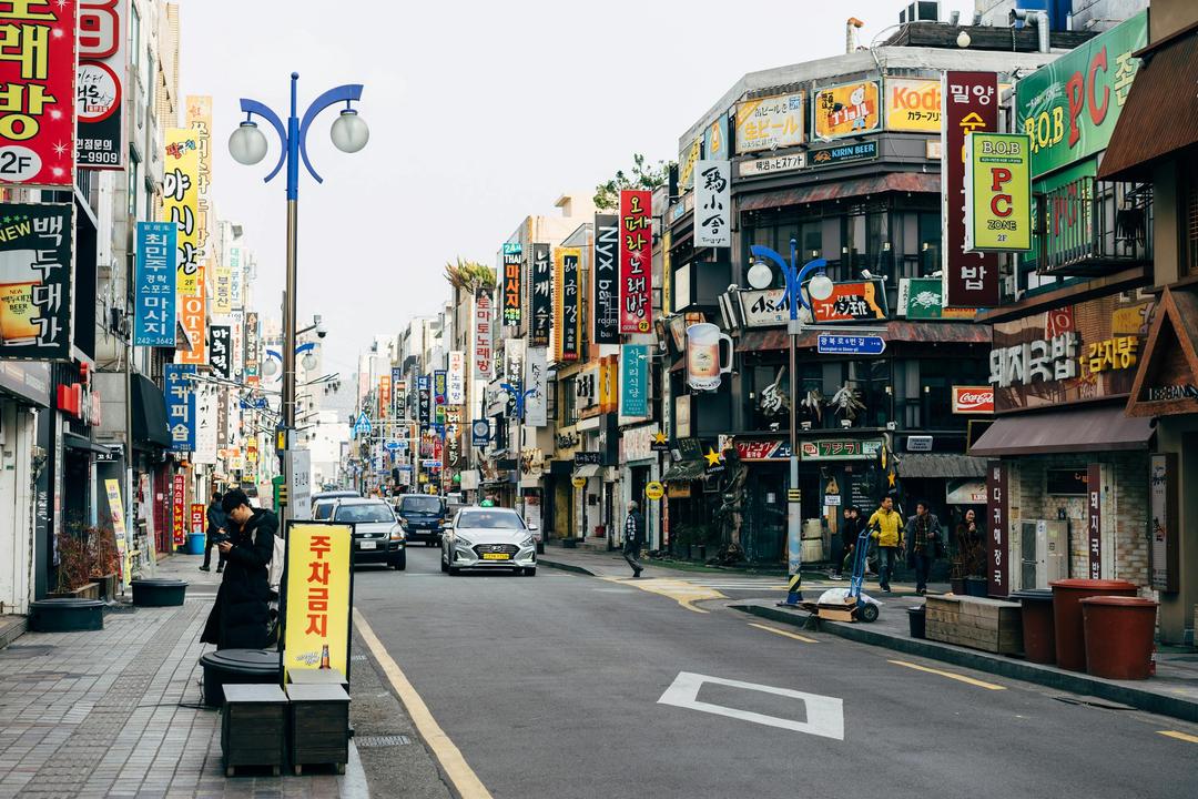 Cars on Street Near Buildings with store Signs